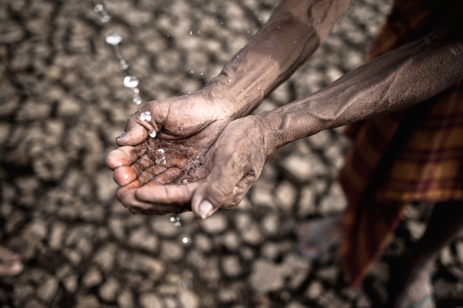 Elderly men are exposed to rainwater in dry weather,global warming,selective focus